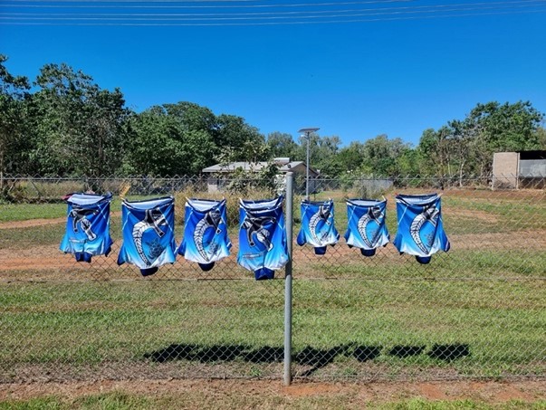 Jerseys hang on a fence to dry.