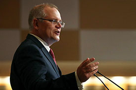 Federal Treasurer Scott Morrison standing at a podium, speaking