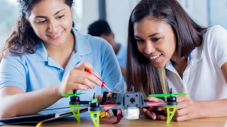 School girls working on a drone in a tech class