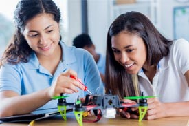 School girls working on a drone in a tech class