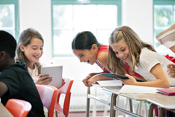 Happy students chatting in class