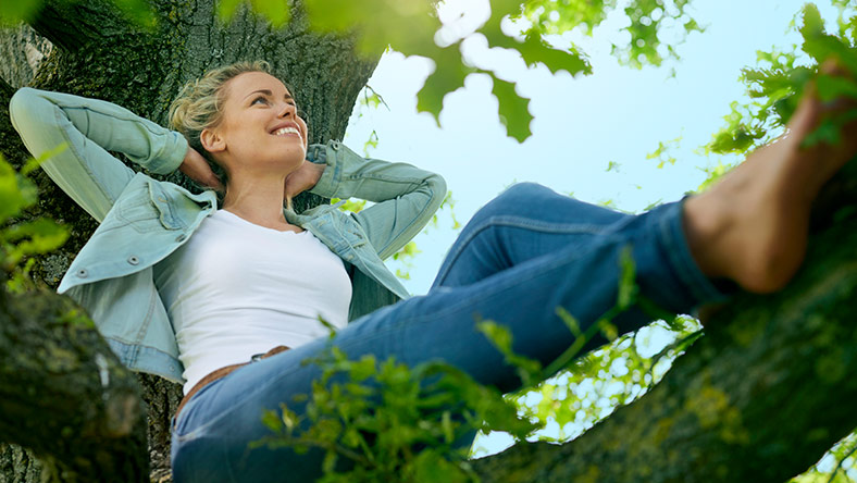 Happy woman relaxes in nature