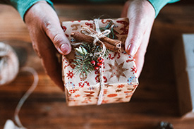 Top down view of a woman holding a wrapped present.