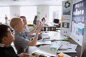 Students in class working on recycling and sustainability project