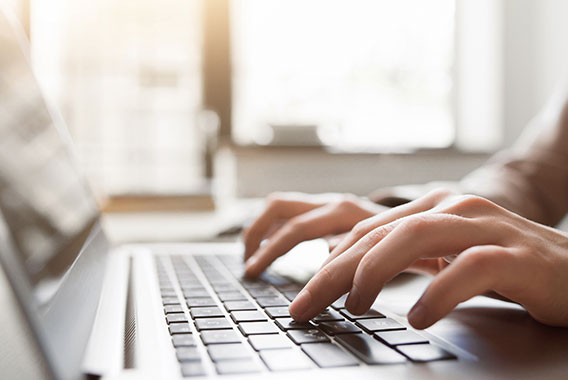 Person typing on a keyboard as they surf the internet