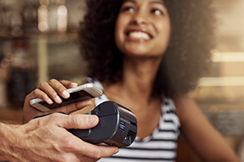 Woman making card payment using her mobile phone