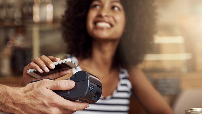 Woman making card payment using her mobile phone