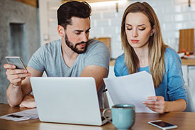 Couple sit at table with document