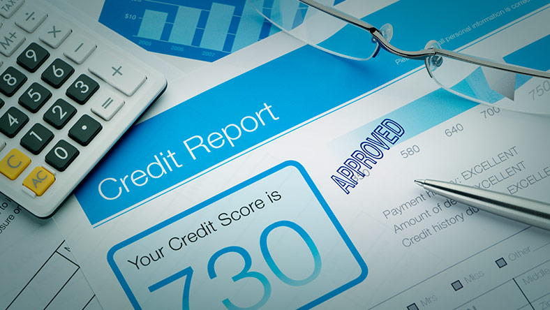 credit report document beside calculator