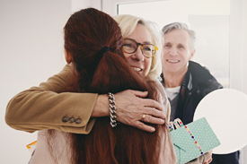 A mother hugs her daughter as she makes a decision between a gifted home loan deposit or guarantor.