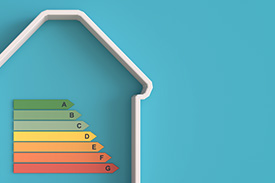 A cookie cutter resembling a house with coloured labels inside.