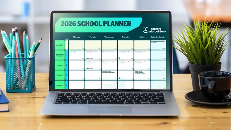 A laptop on a wooden desk shows a digital 2026 school planner with a clear weekly calendar layout.